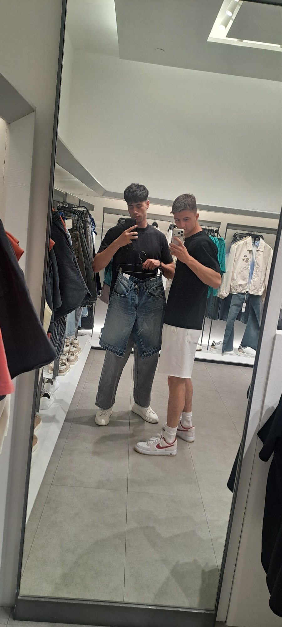 Two men take selfie in Burgas clothing store mirror