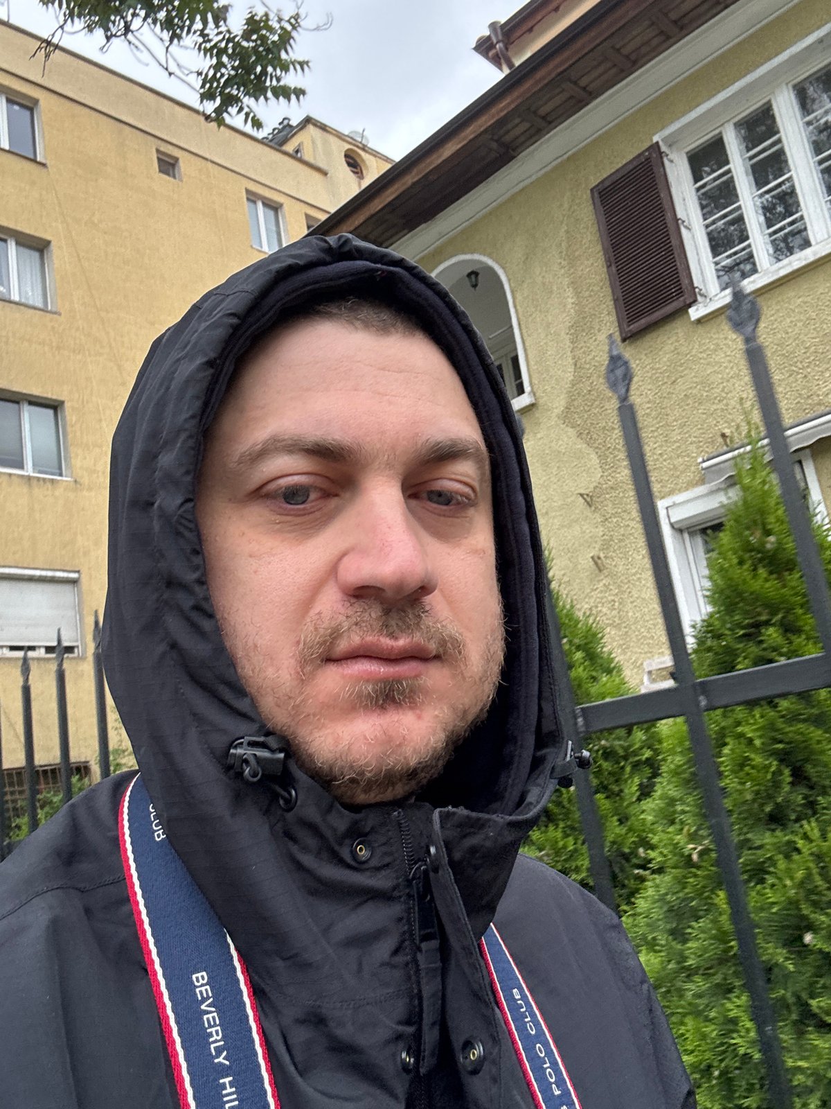 Man takes morning selfie in Sofia wearing hooded jacket