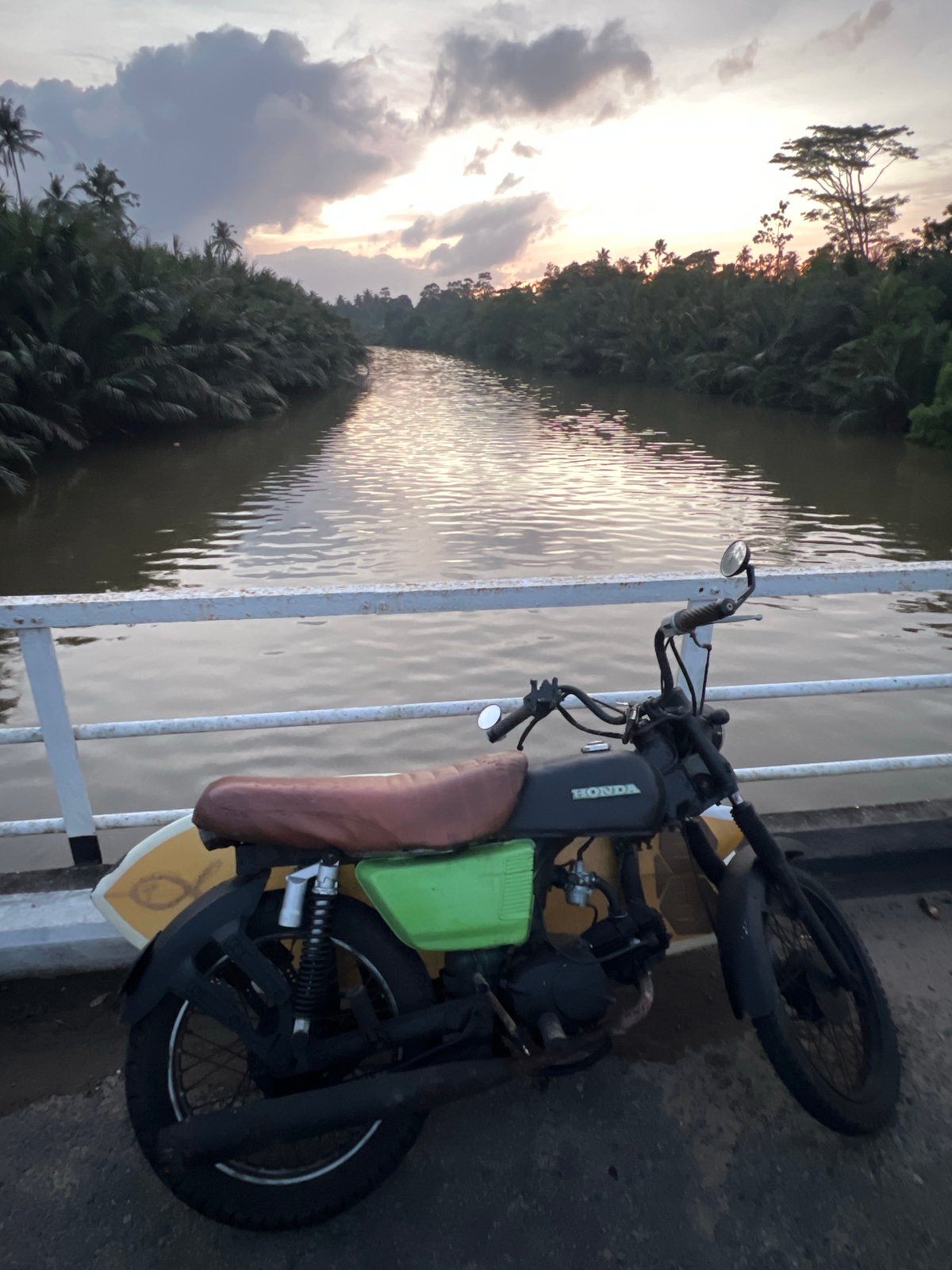 Sunset river views and motorcycle surfboard setup in Sri Lanka
