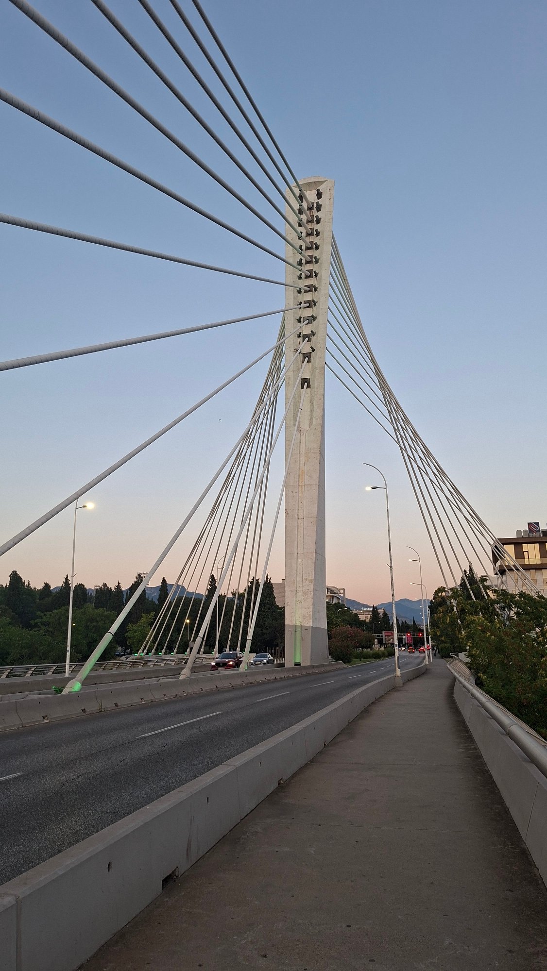 Podgorica's Millennium Bridge and city center at dusk