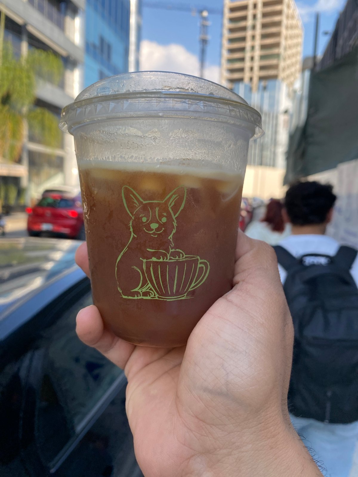 Cold brown beverage with foam served in decorated cup in Puebla