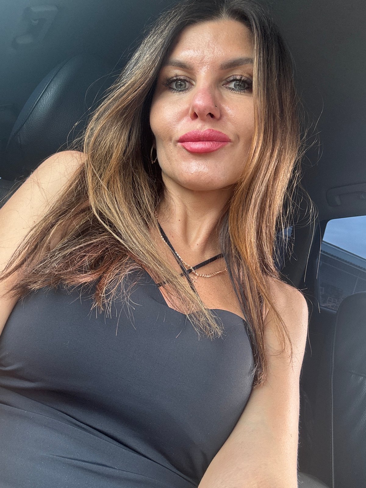 Woman takes car selfies, man grills outdoors in Chaikovsky
