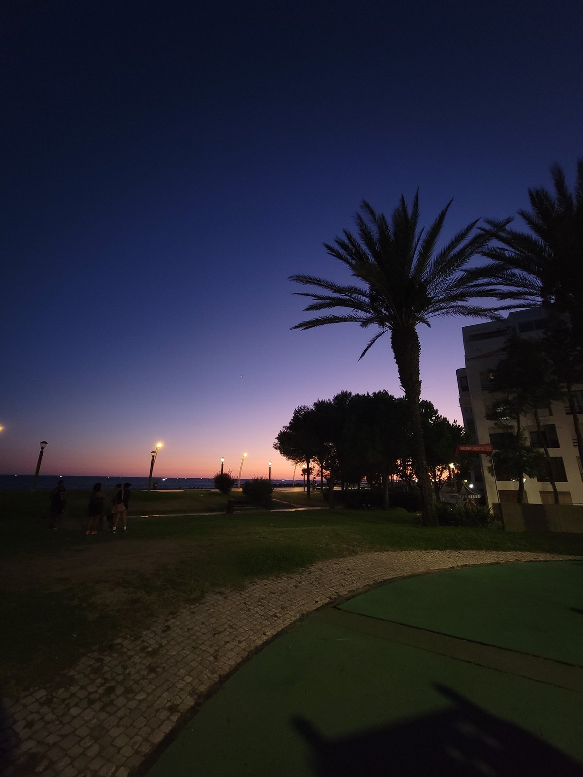 Sunset stroll along Quarteira's seafront promenade