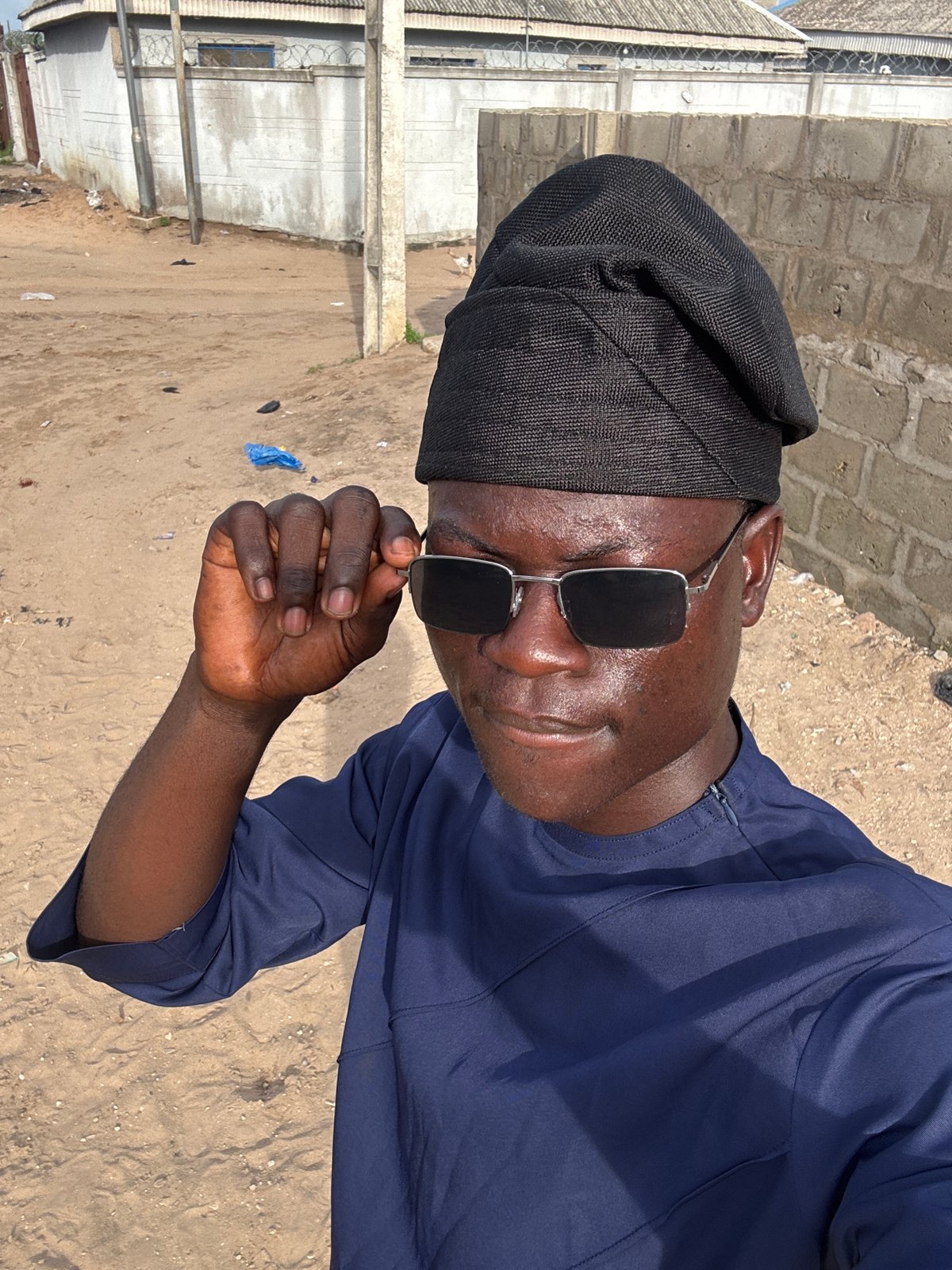 Man in sunglasses photographed multiple times in Badagry, Nigeria