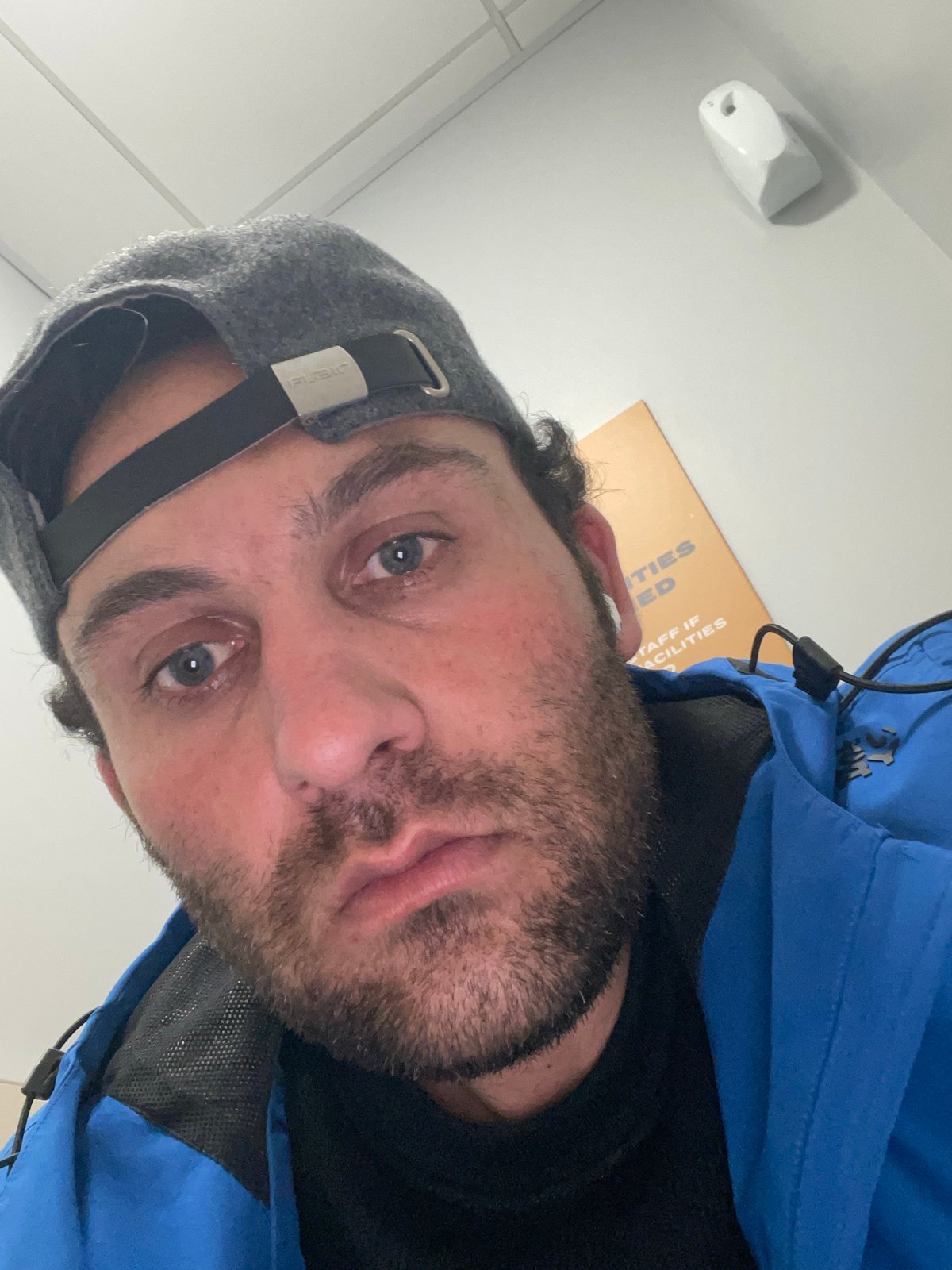 Man takes indoor selfie in Newry with facilities document visible