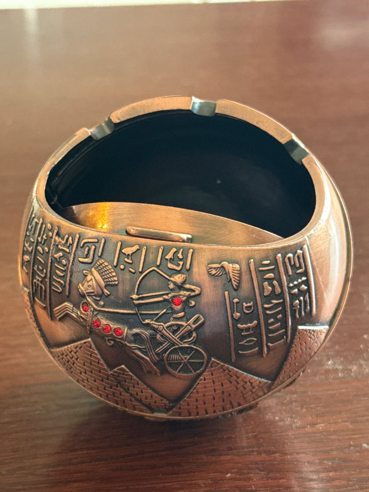 Close-up catalog shoot of Egyptian metal souvenirs and figurines