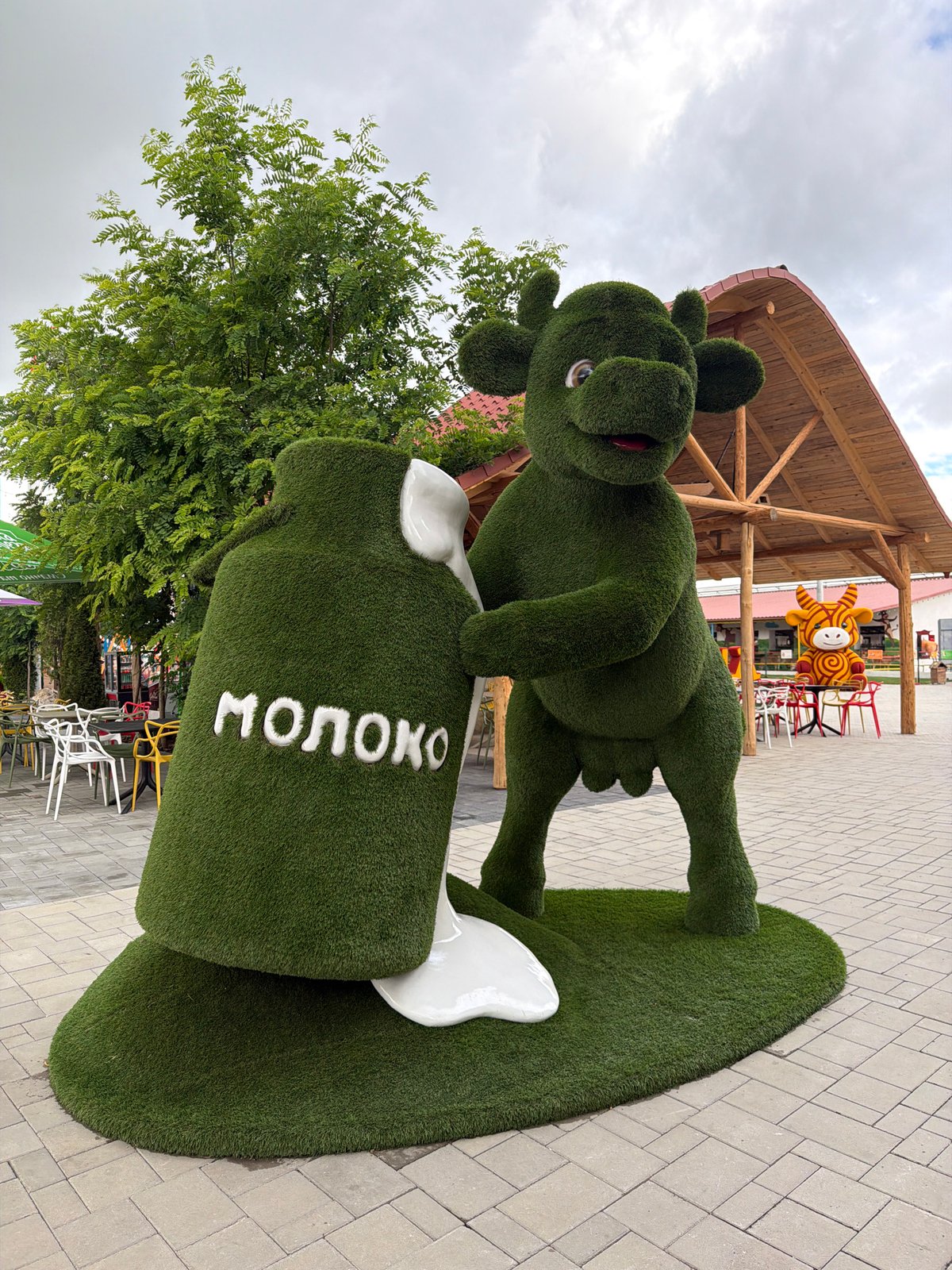 Colorful cow and milk pitcher sculptures in rural Ukraine
