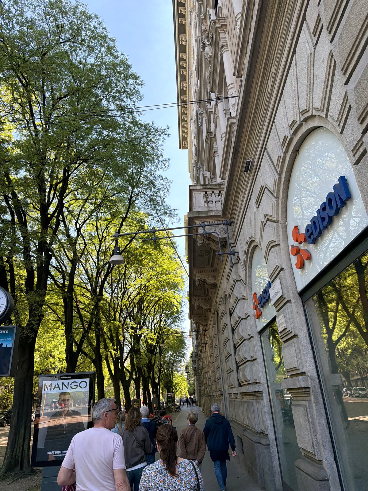 Tourist captures Milan landmarks during afternoon walking tour
