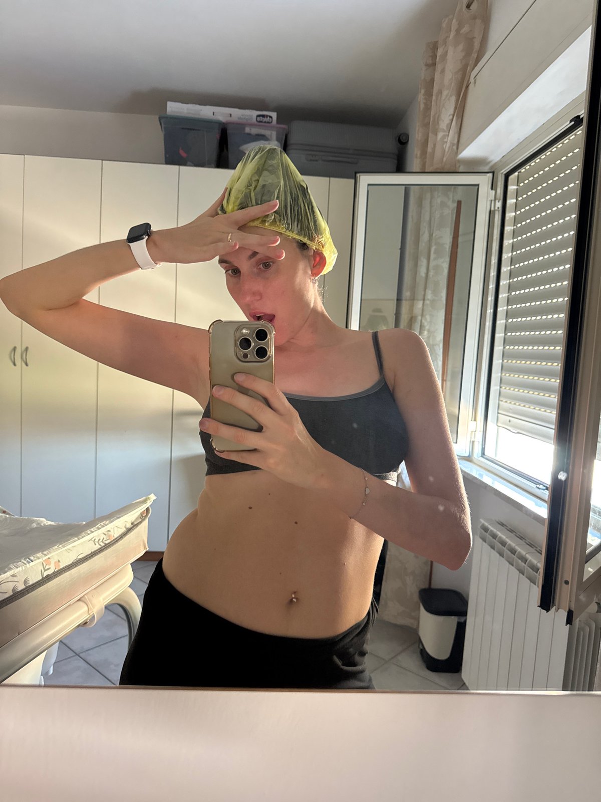 Woman takes workout selfies in yellow shower cap