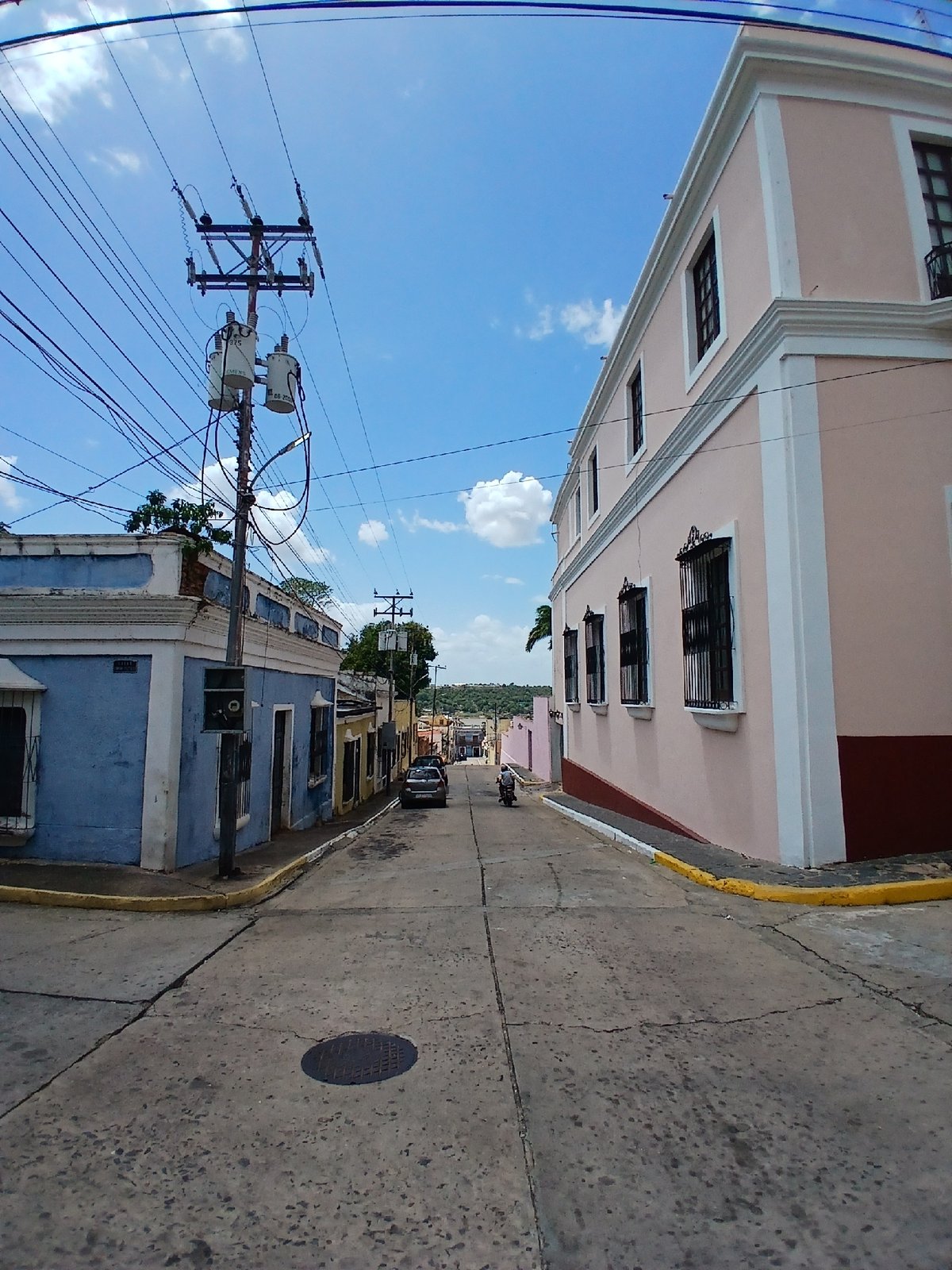 Tourist documents Ciudad Bolivar architecture and South American flag display