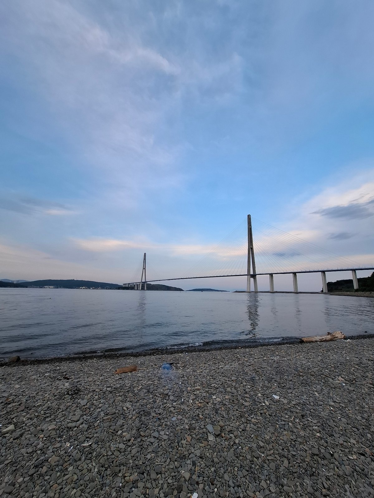 Dusk at Russky Island beach, bridge and shoreline in focus