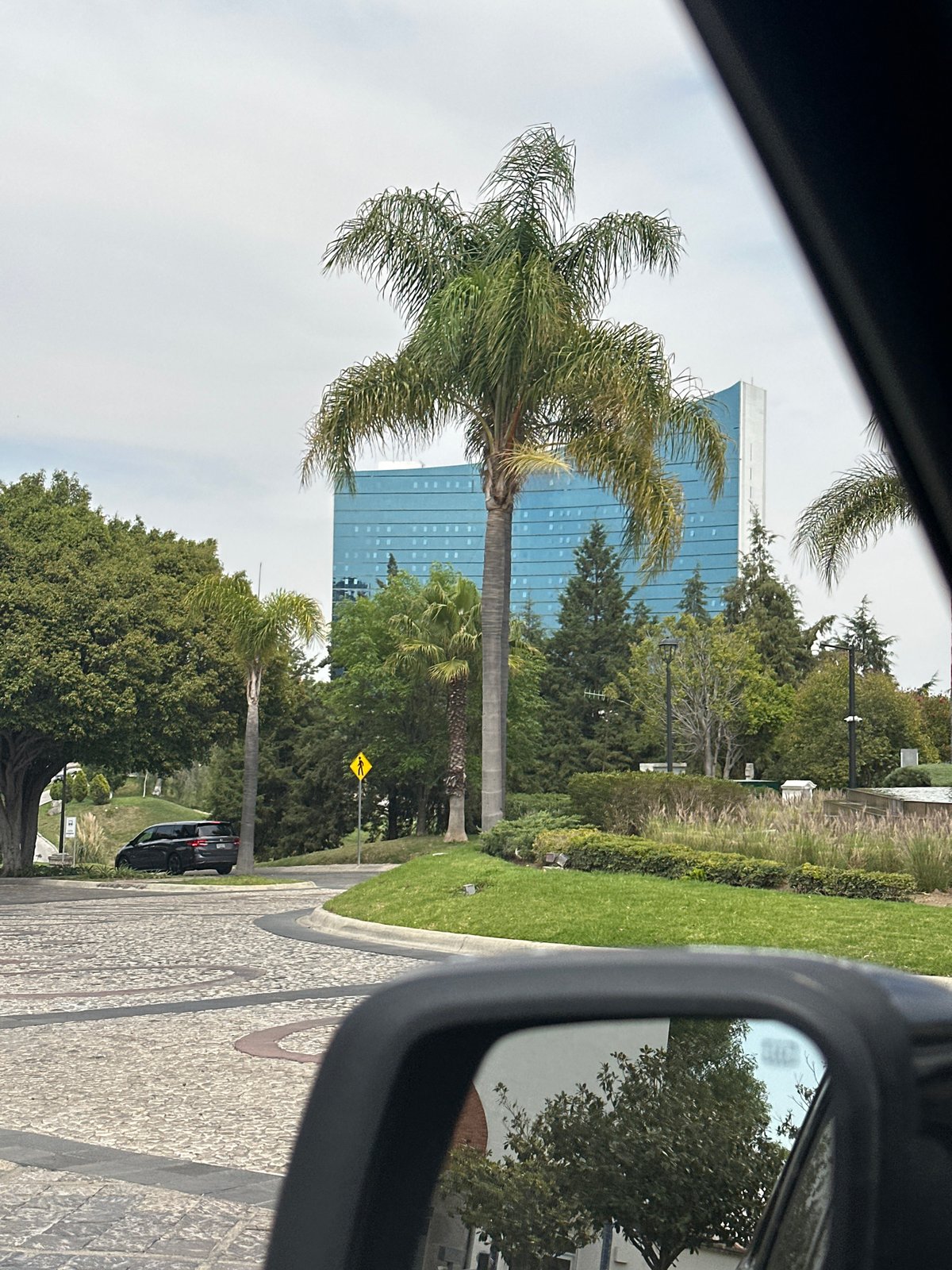 Modern blue office building observed from car in Tlaxcalancingo