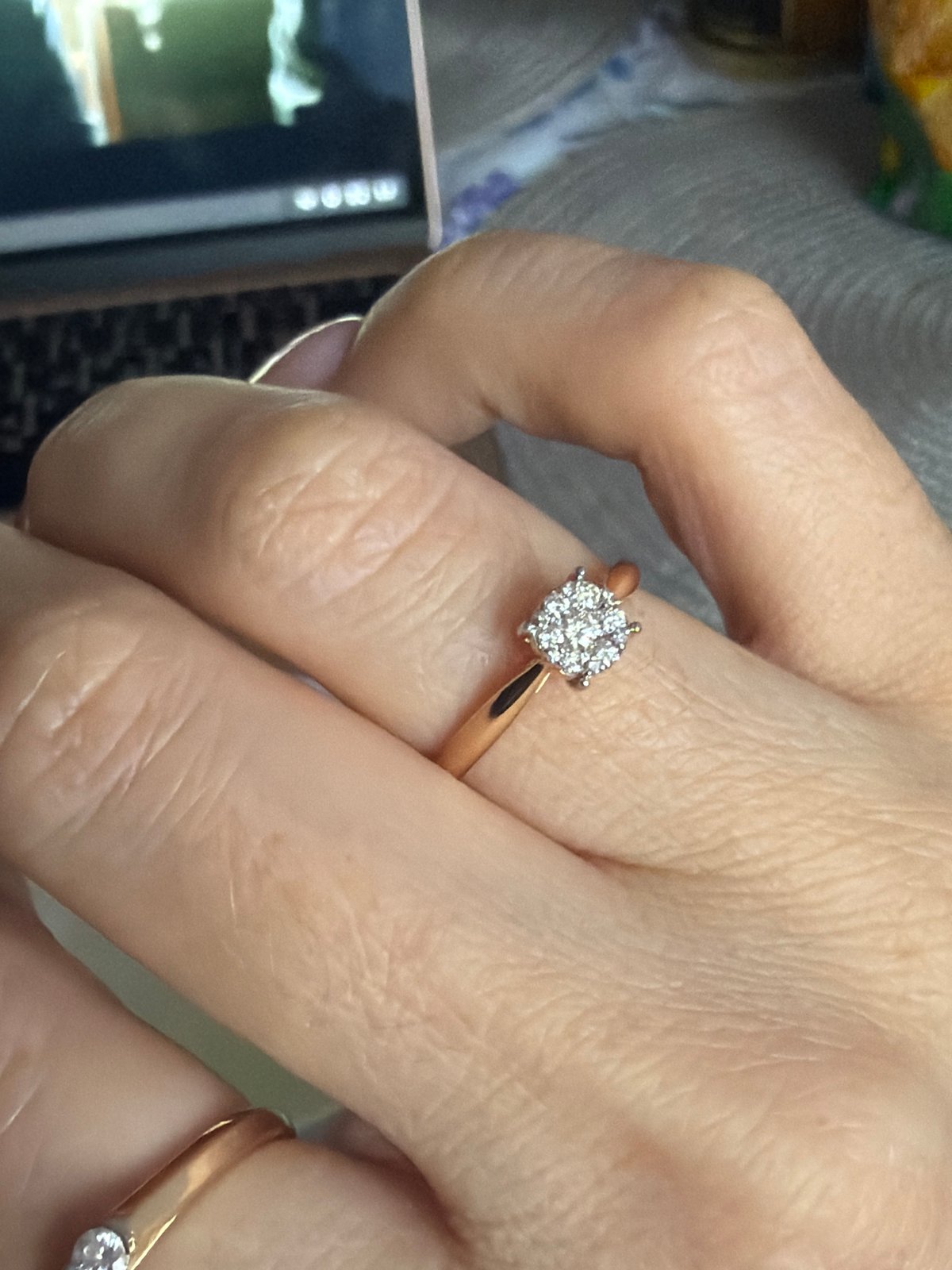 Person displays manicured hand with diamond rings in Saint Petersburg