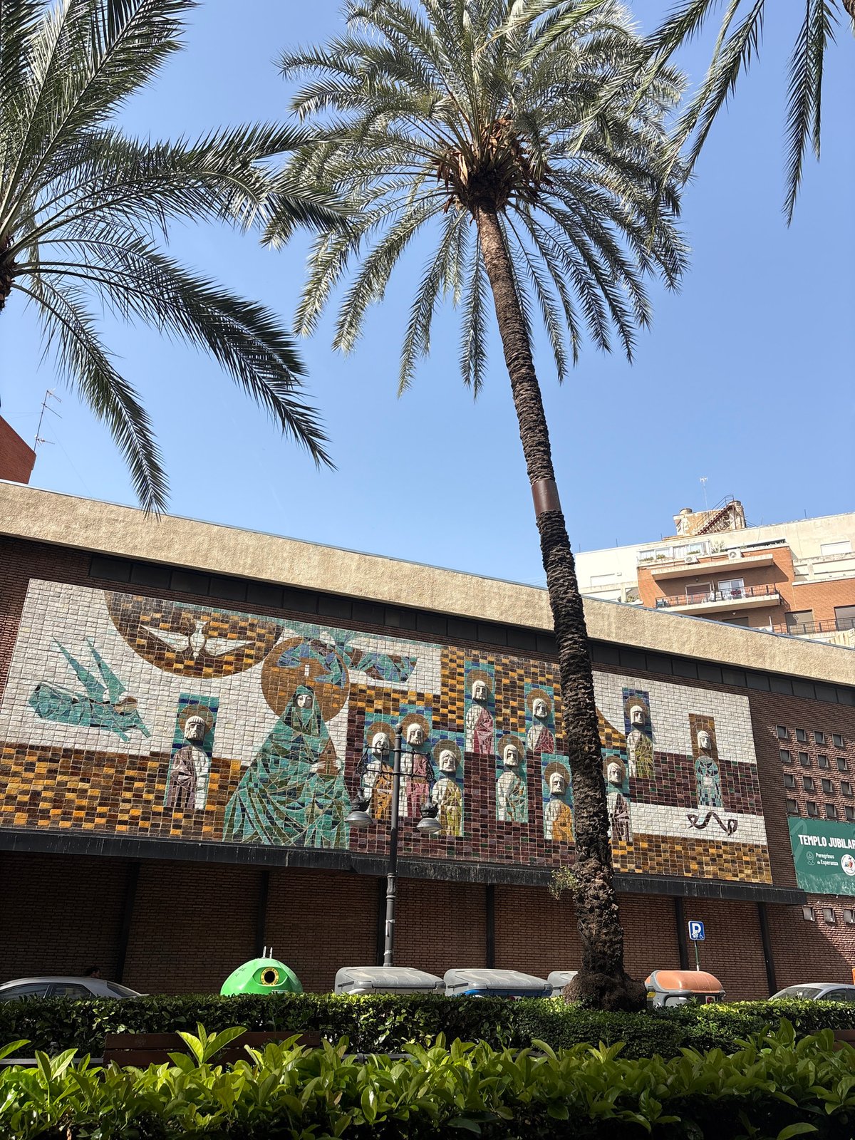 E-scooter ride past a mosaic-covered building in Valencia