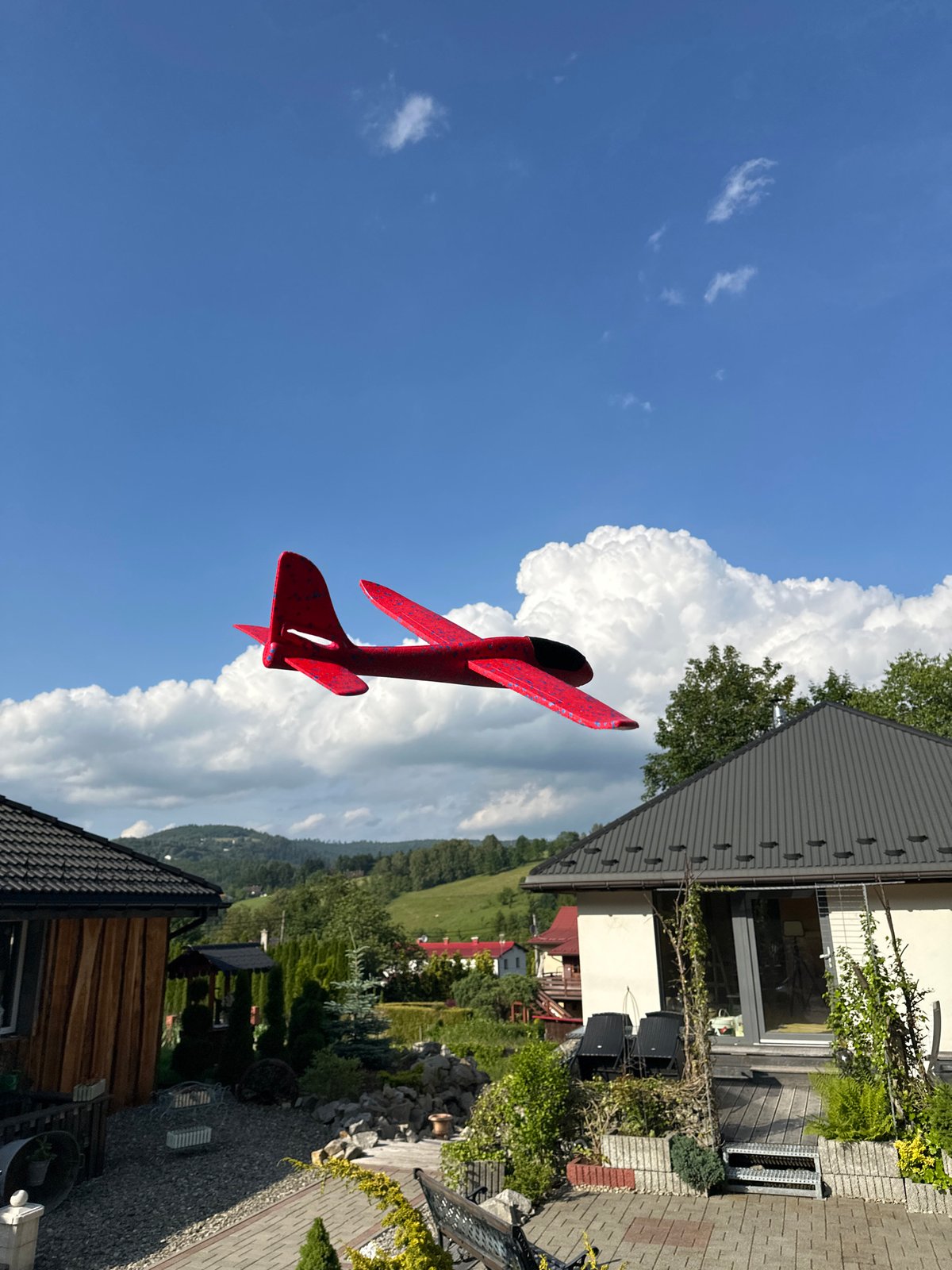 Backyard play and toy airplane flights over hilly Wisła
