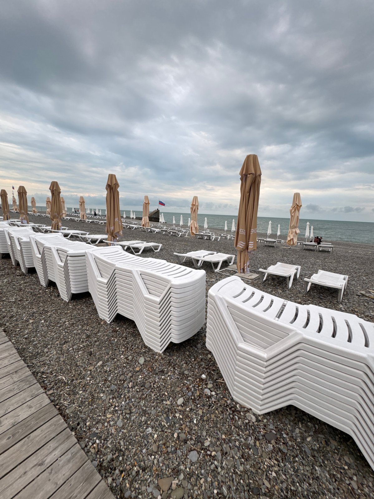 Quiet afternoon captured at Sochi pebble beach under cloudy skies