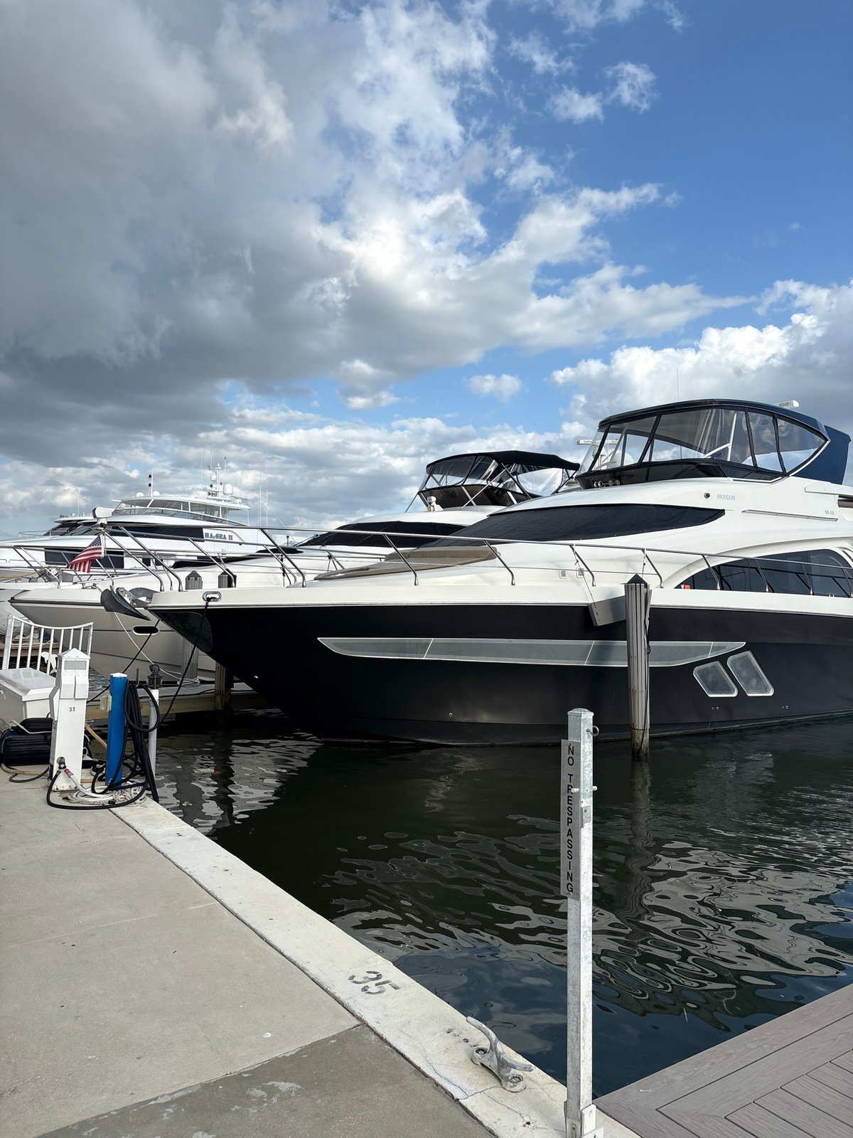 Luxury yachts documented at marina during evening hours
