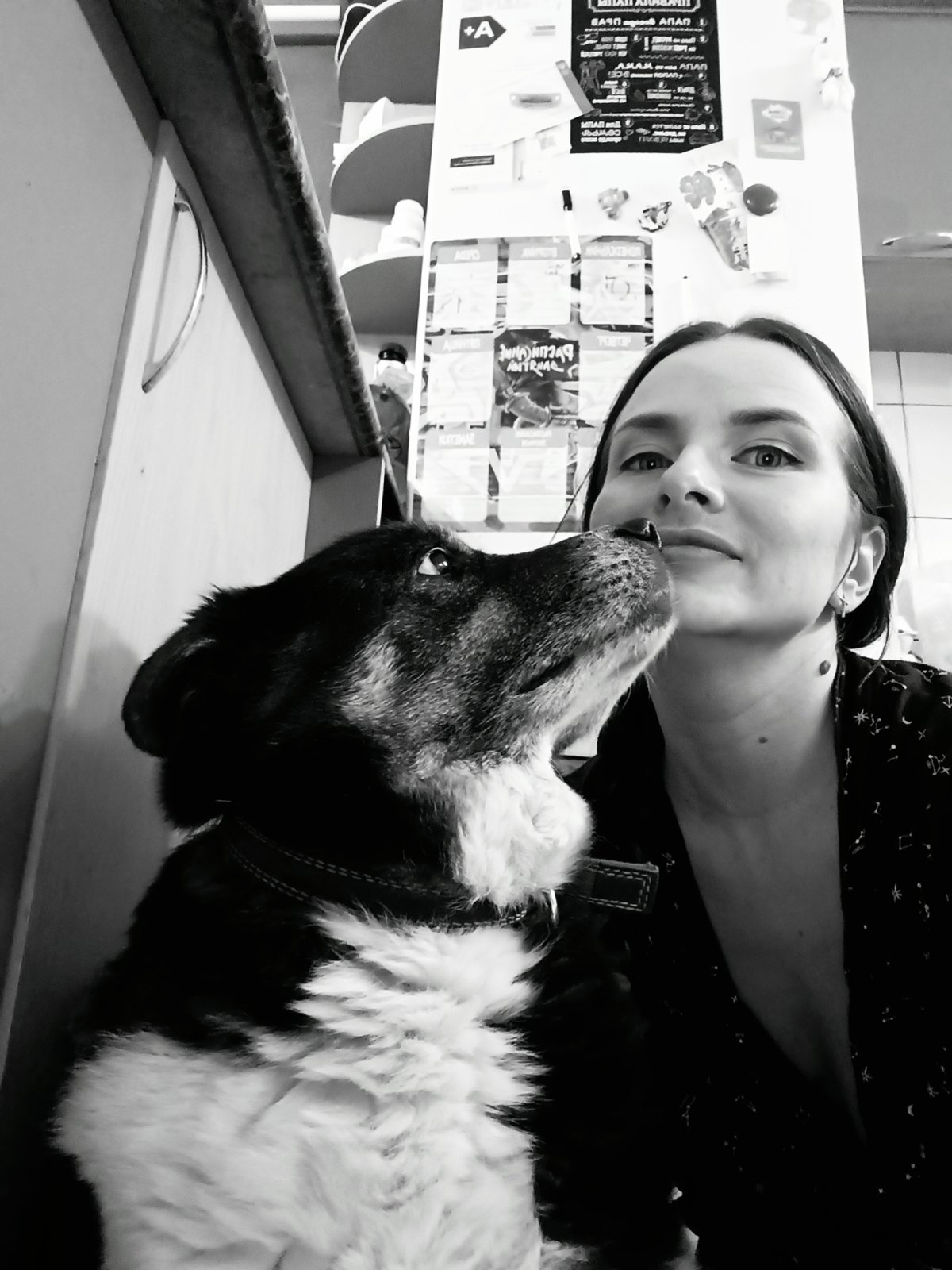 Woman and dog share affectionate moment in Rusalevka home