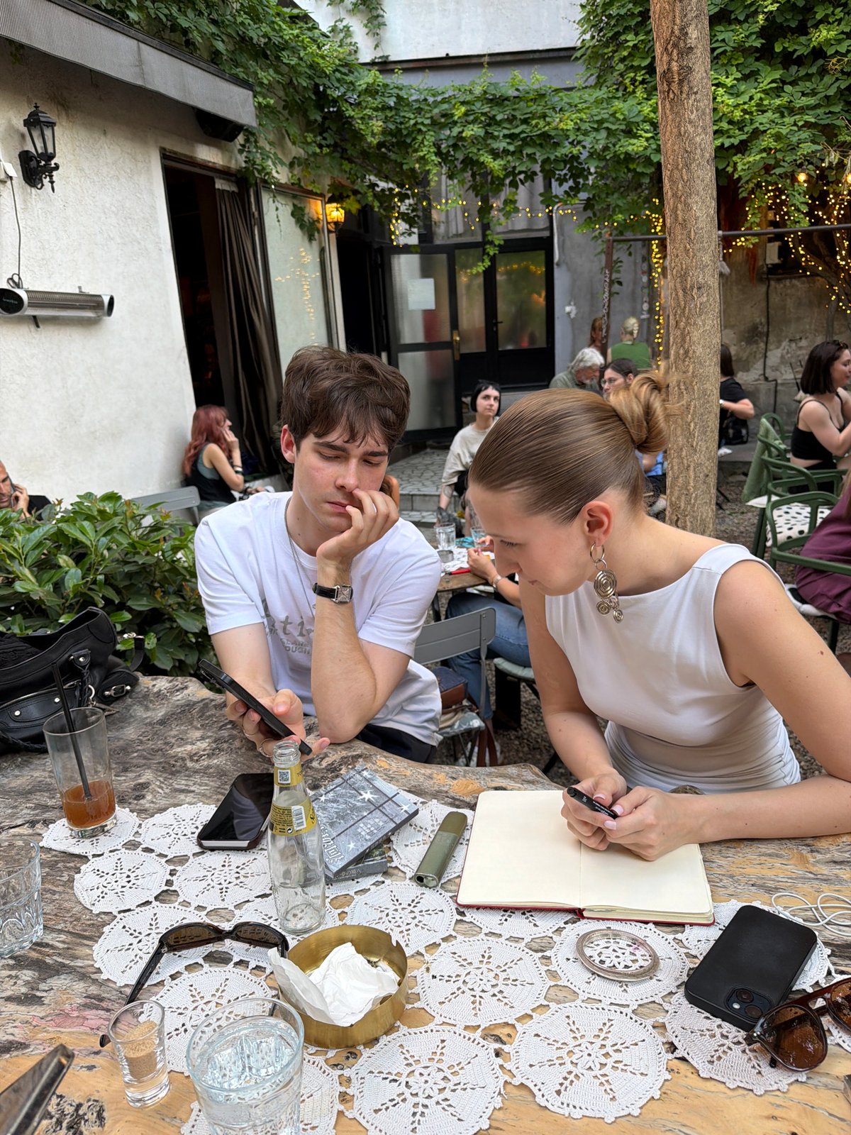 Afternoon cafe socializing captured in Belgrade courtyard garden