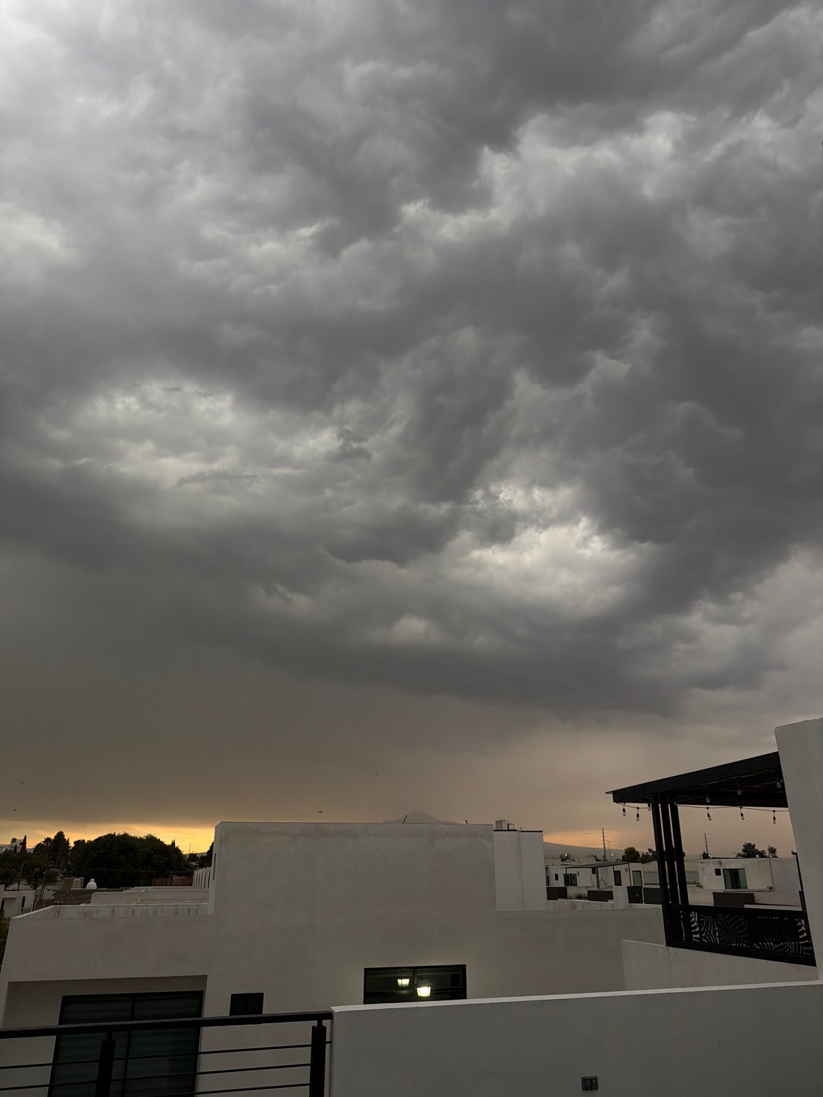 Storm clouds create dramatic lighting over Cholula, Mexico