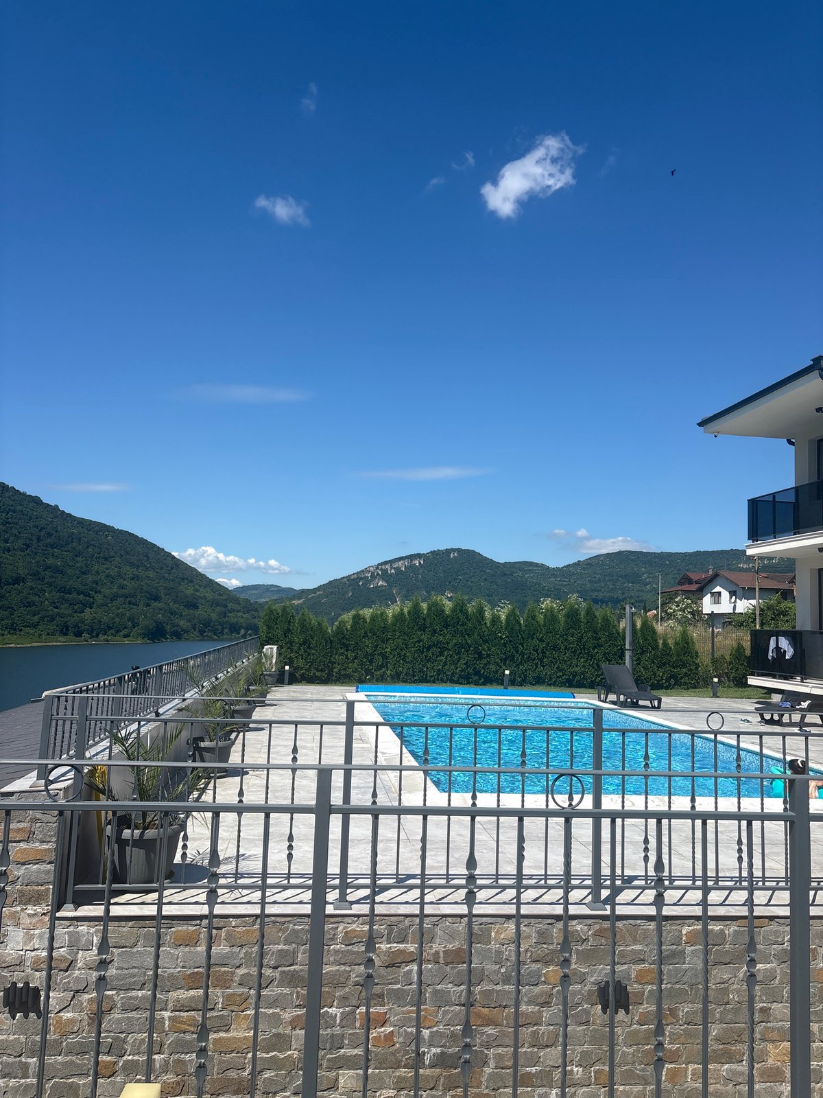 Lakeside property with pool overlooking forested hills
