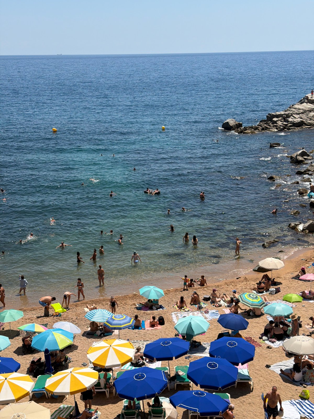 Crowded summer beach day on the Costa Brava