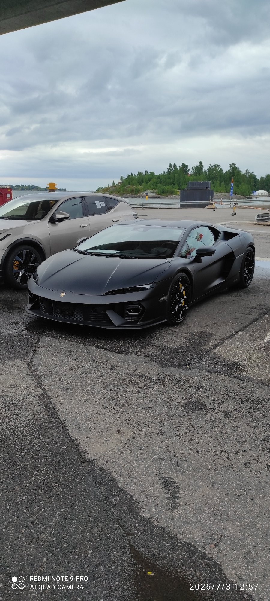 Matte black Lamborghini parked waterside in Helsinki