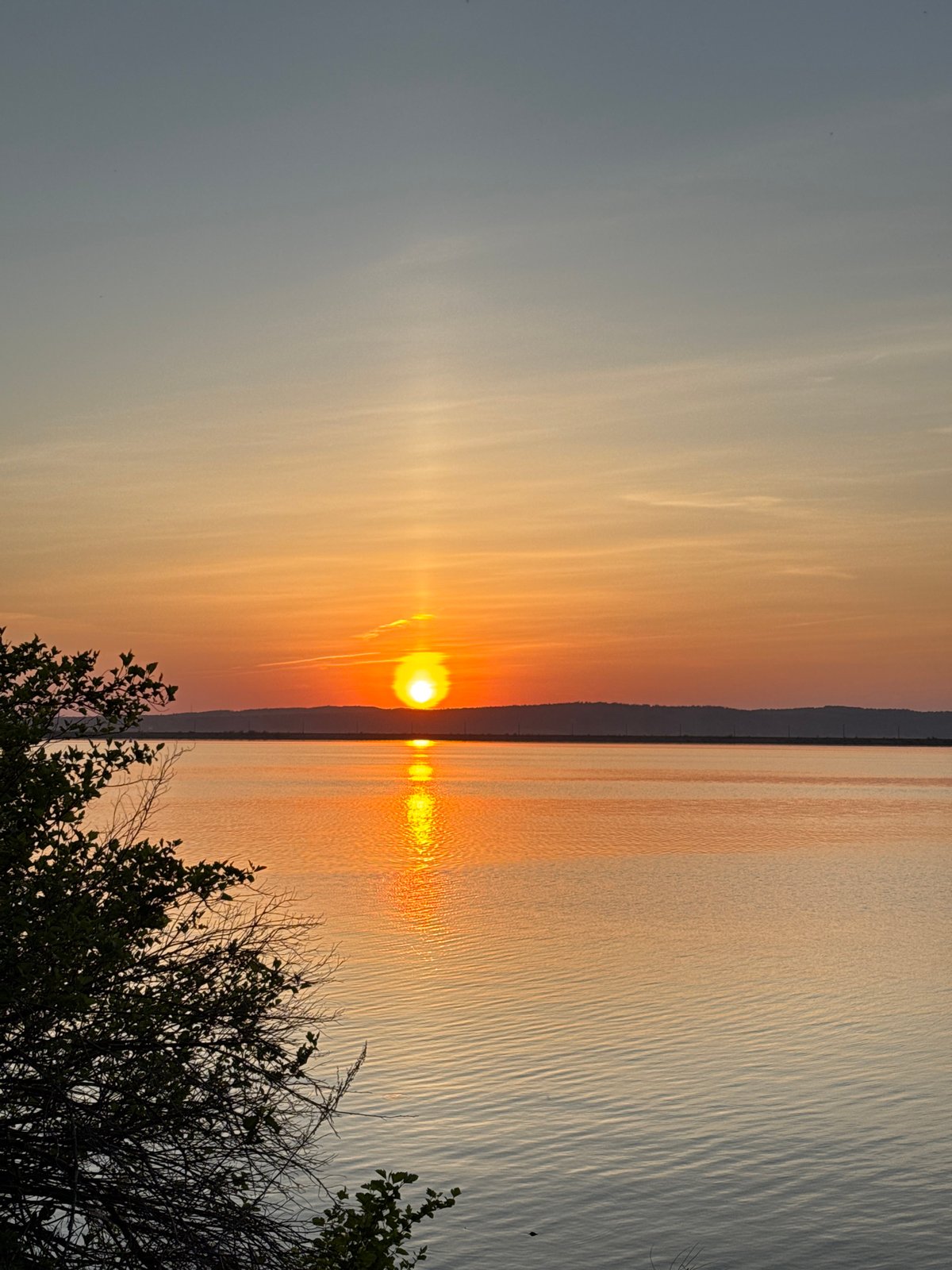 Woman enjoys riverside sunset in Chaikovsky, Russia