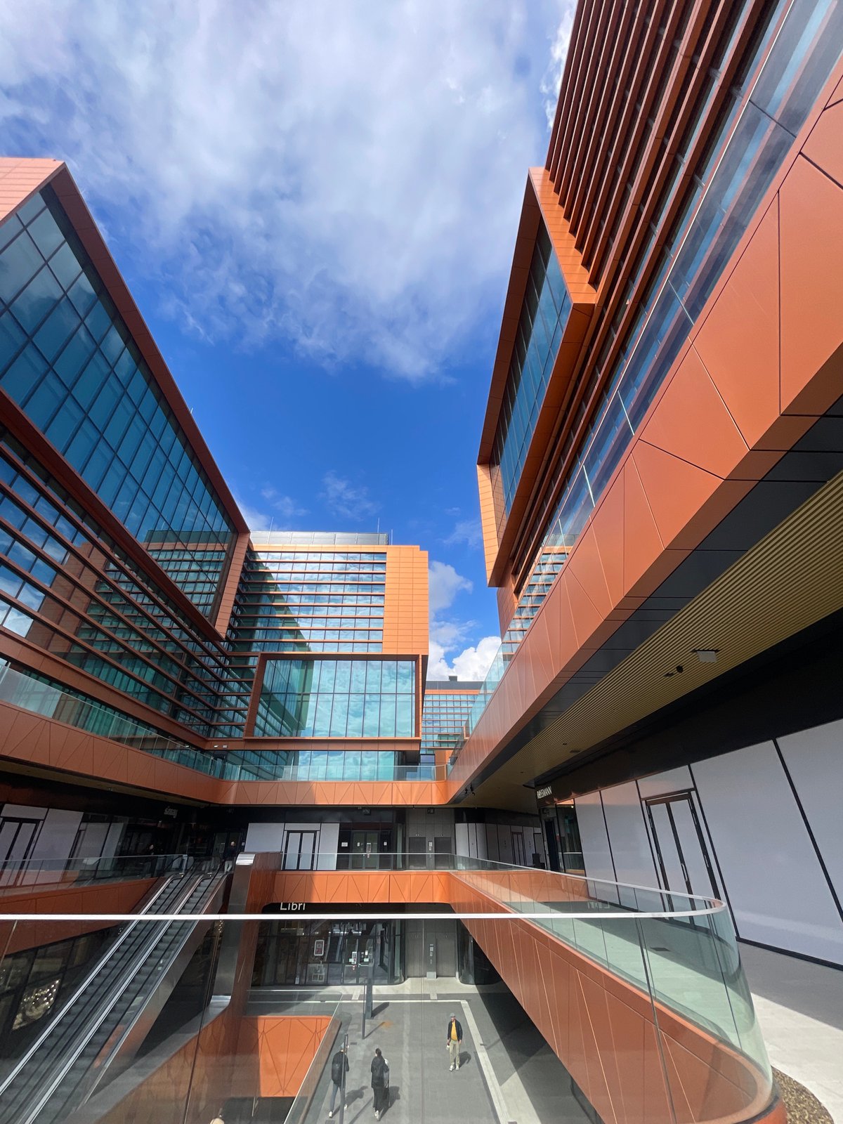 Visitor documents modern Budapest architecture complex in afternoon photo session