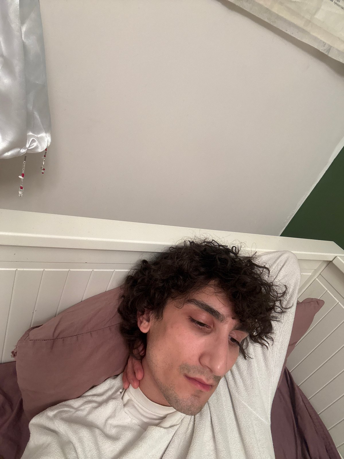 Young man resting in Moscow bedroom late evening