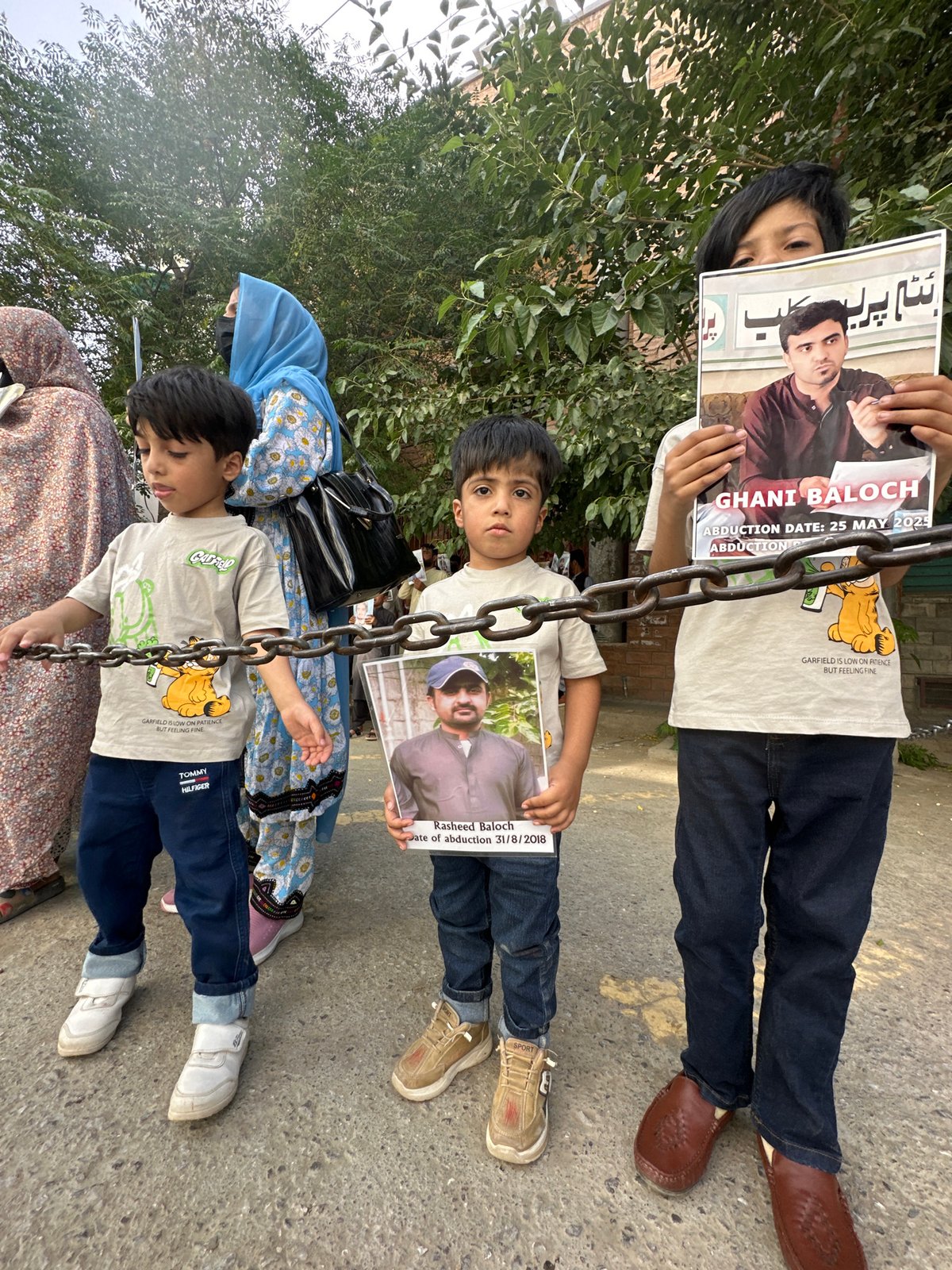 Families protest in Quetta holding photos of missing persons