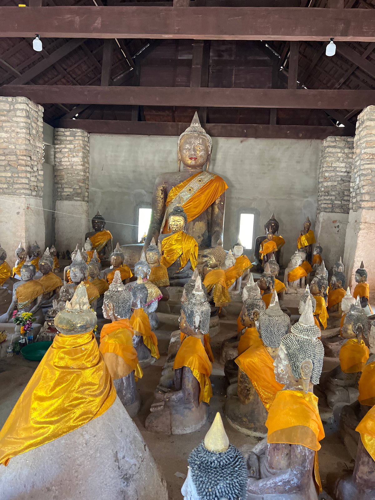 Visitors document Buddha statues at Baan Harn temple, Thailand