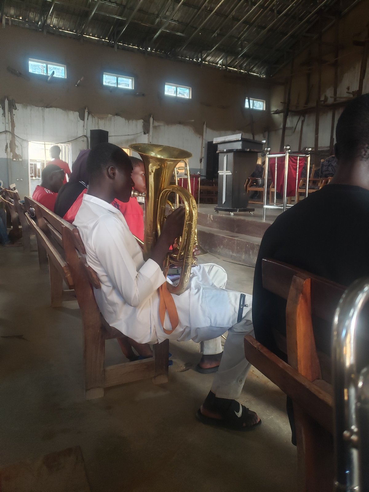 Indoor gathering with tuba player in community space