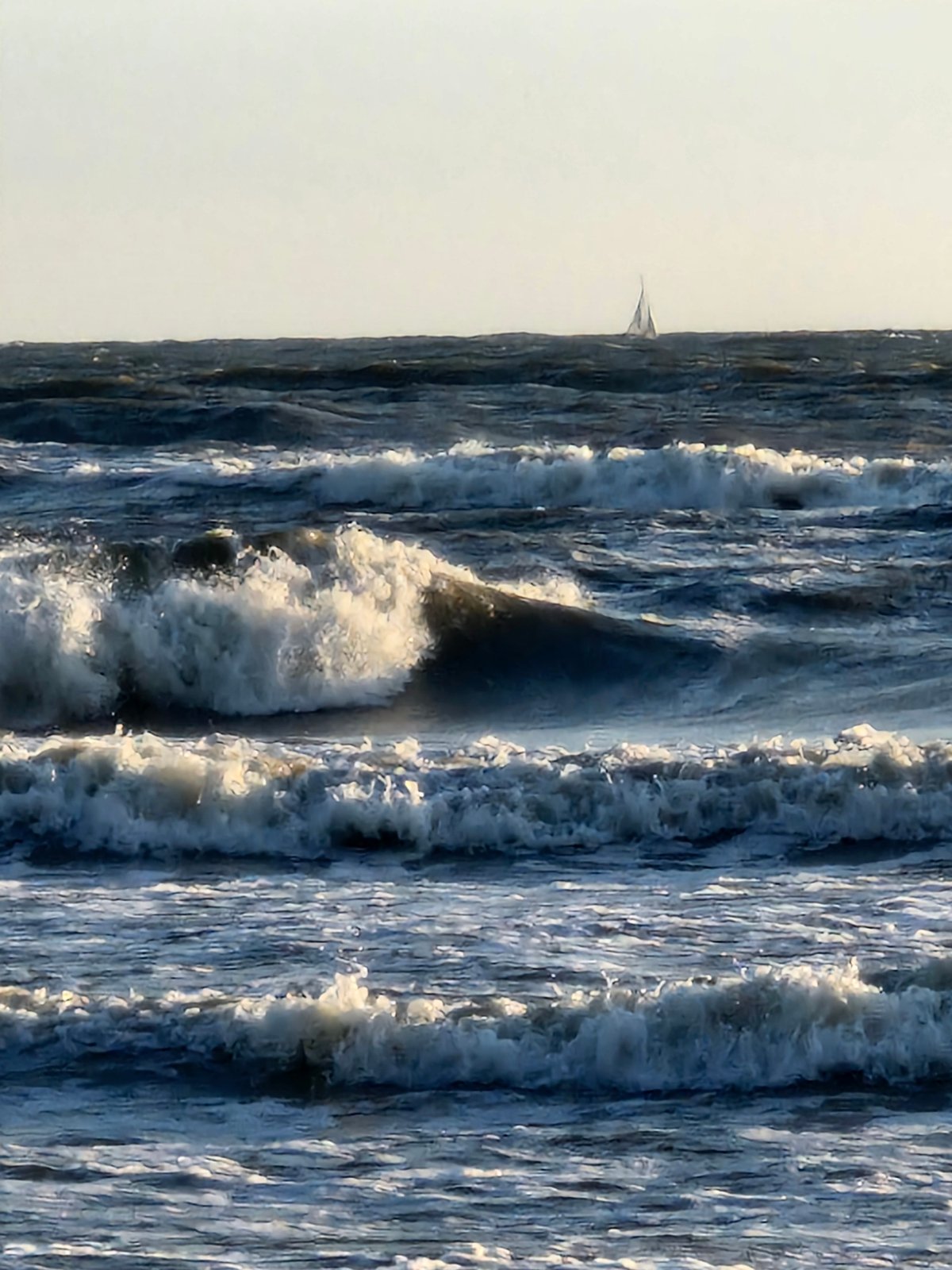 Kitesurfing, swimming, and sailing in choppy late-day seas