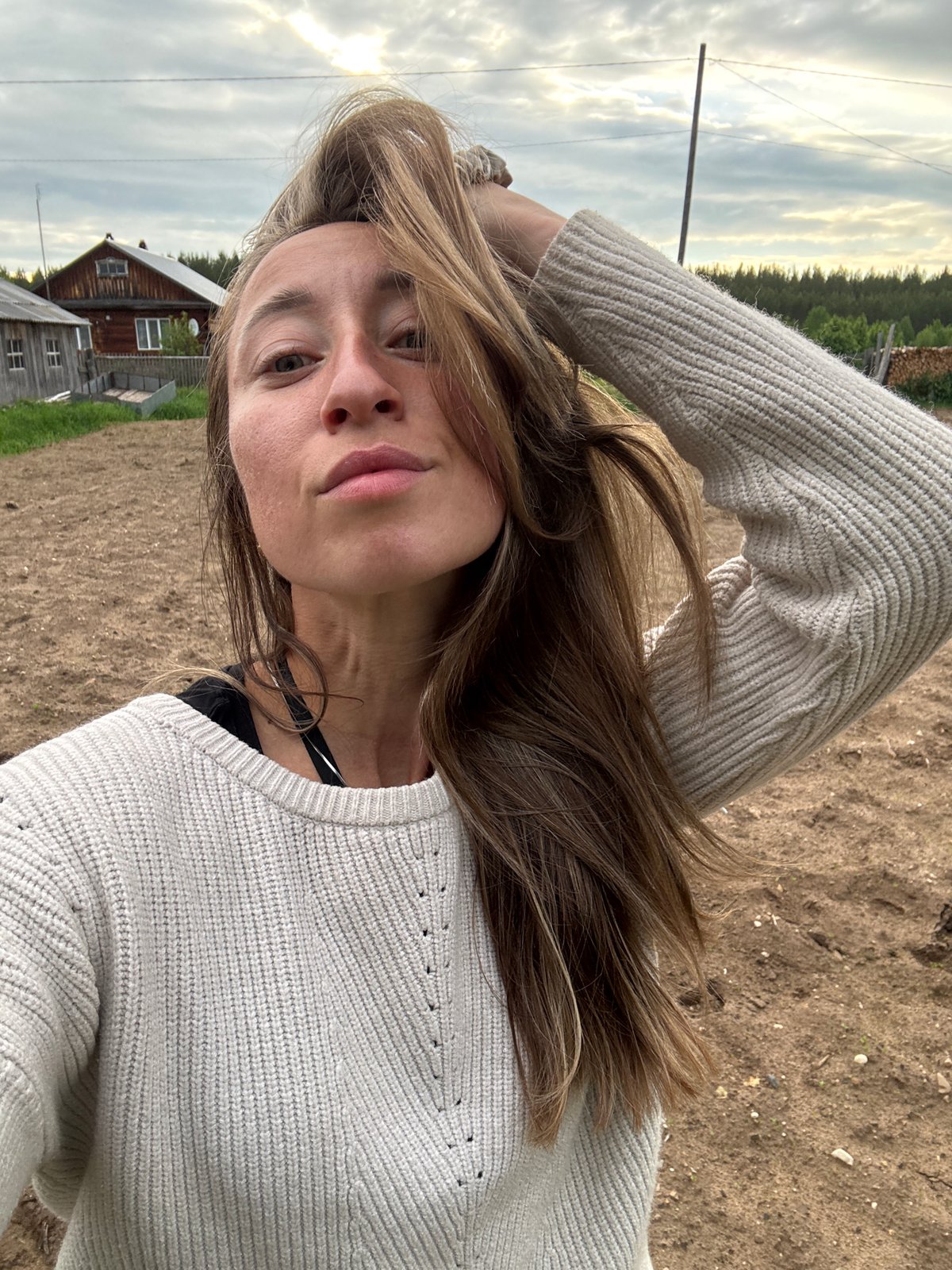 Woman documents outdoor fire gathering in rural Russia