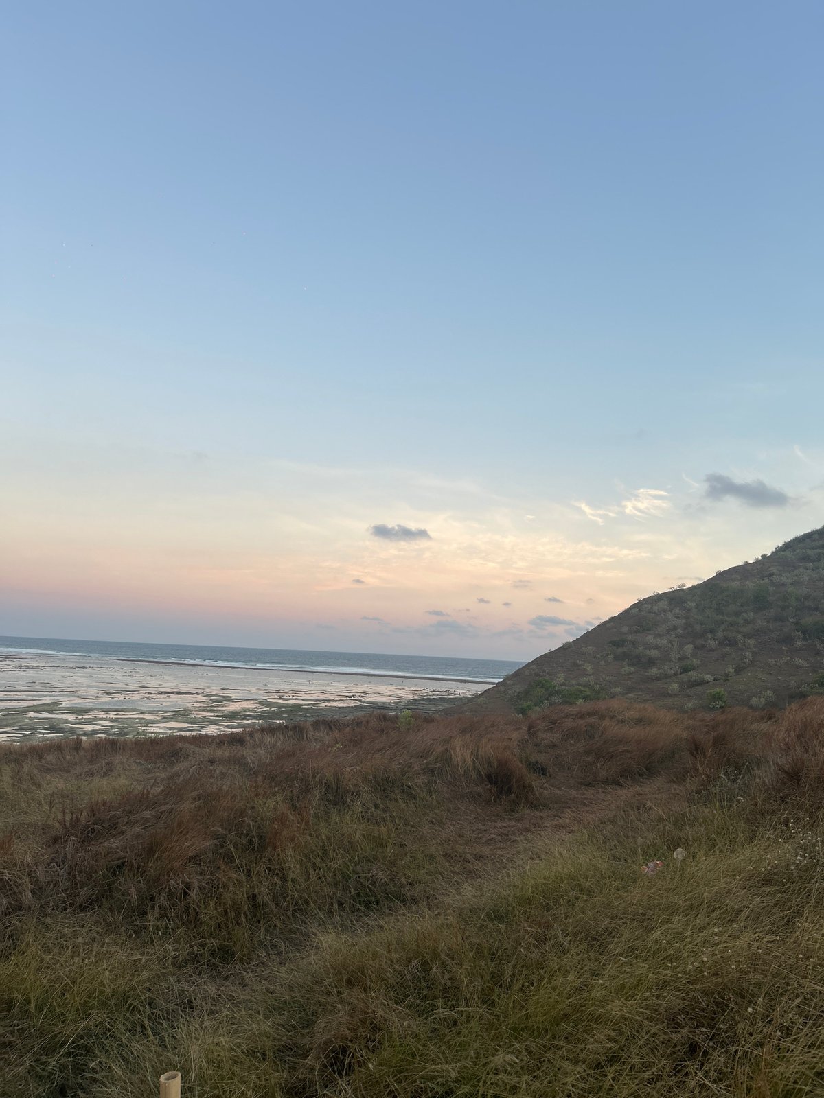 Coastal dusk views and a motorbike lot in Kuta, Indonesia