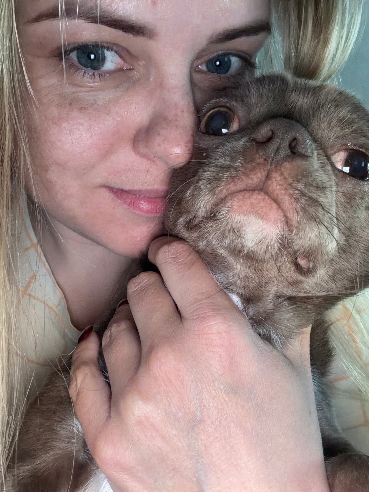 Woman plays with small dogs in Votkinsk apartment