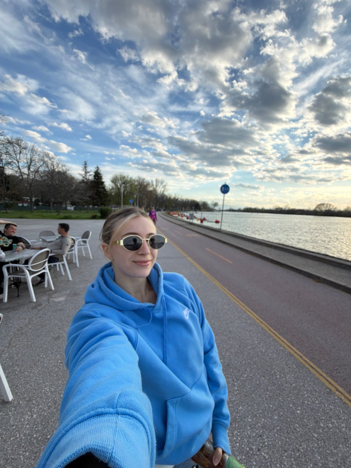 Friends enjoy afternoon drinks at lakeside cafe in Plovdiv