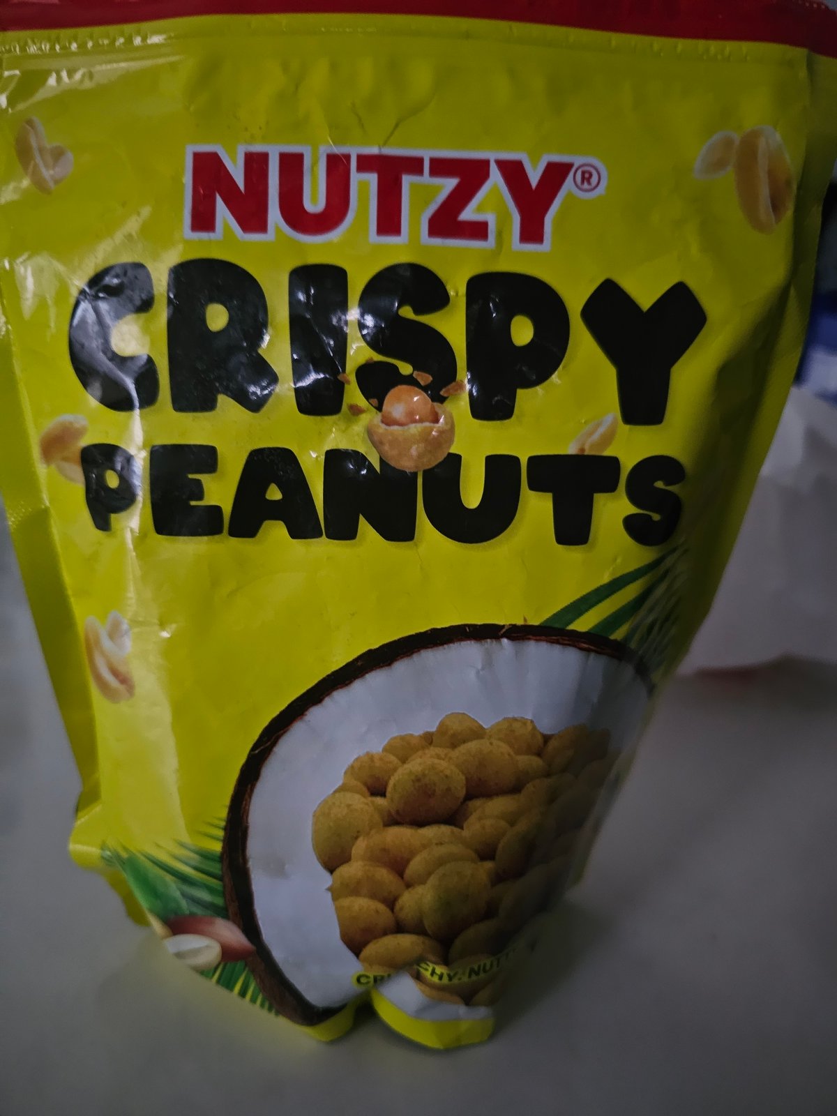 Yellow peanut snack bag photographed against grey background