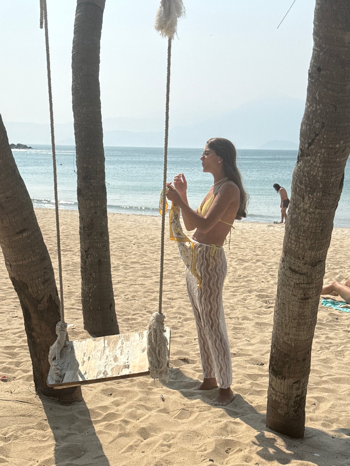 Beachgoers relax with coconut drinks at Đà Nẵng beach