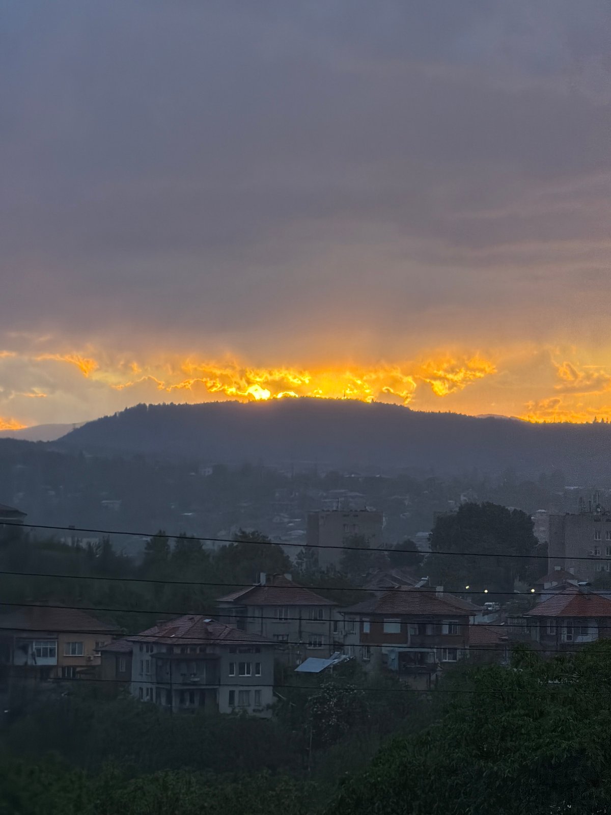Golden sunset observed through clouds over Kardzhali, Bulgaria