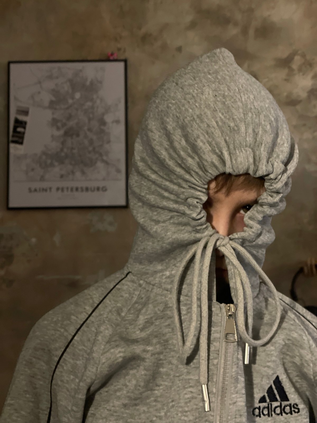Hooded figure observed from above, face mostly obscured