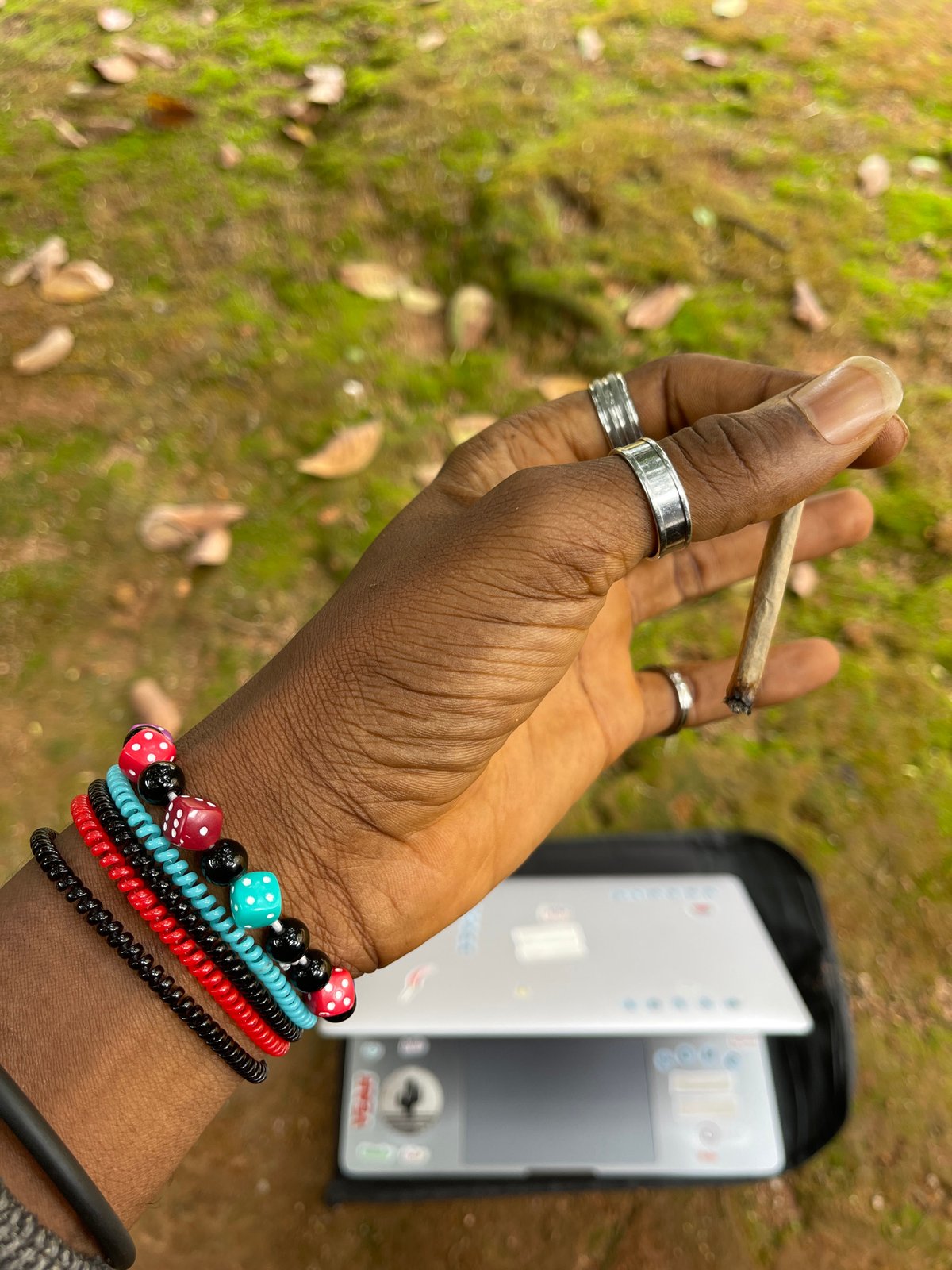 Man photographed smoking, using laptop outdoors in Jos, Nigeria