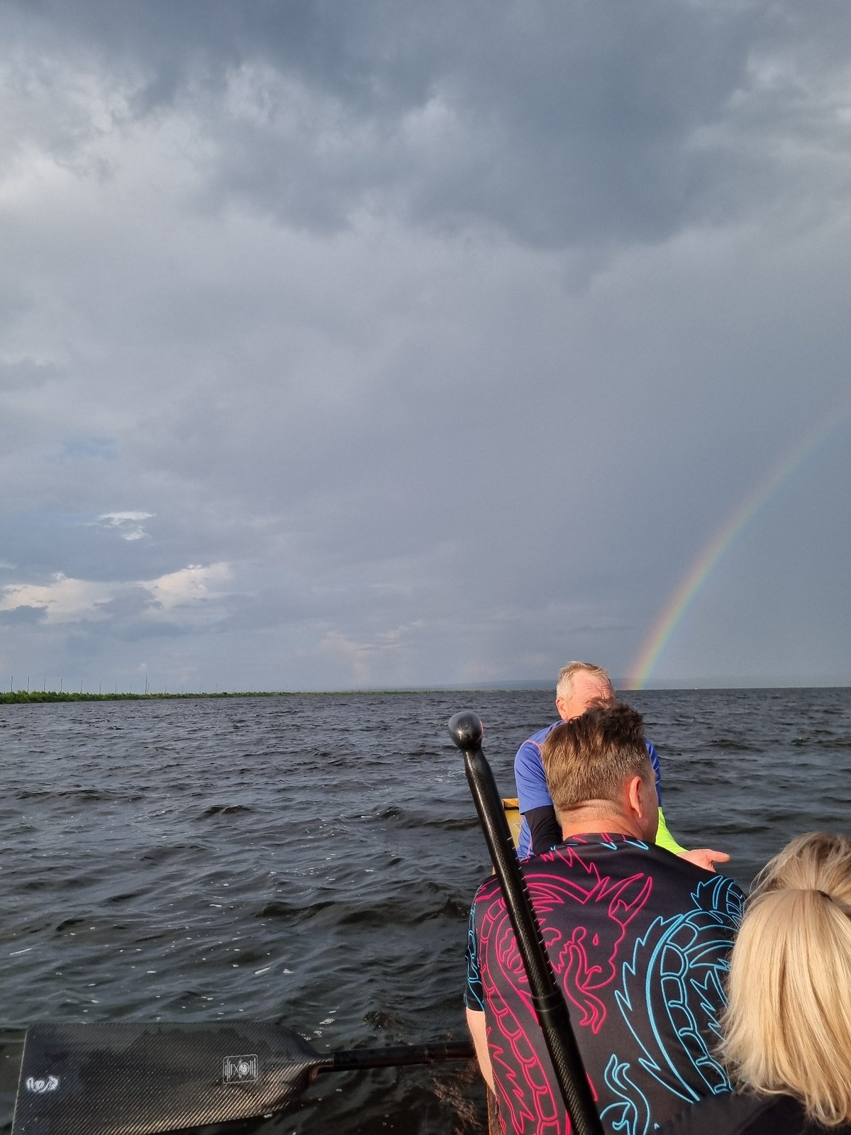 Boat ride on a Russian river under a rainbow sky