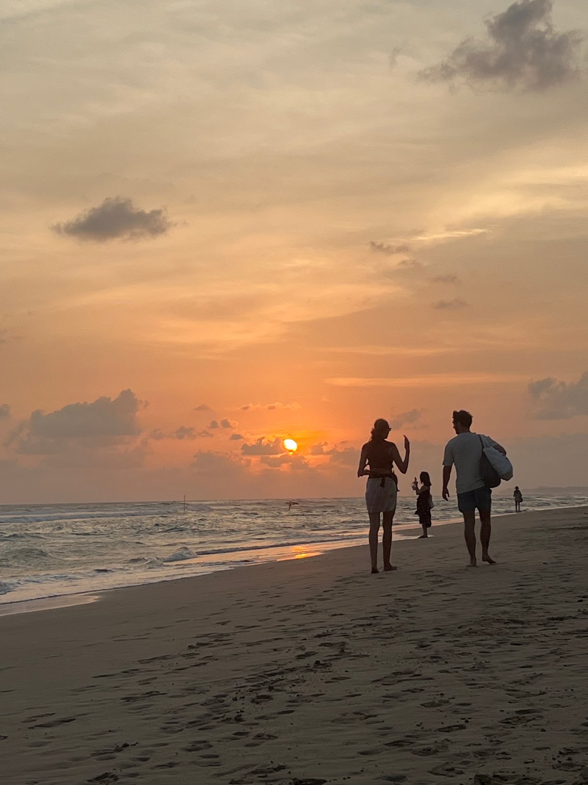 Family enjoys sunset stroll on Kathaluwa beach, Sri Lanka