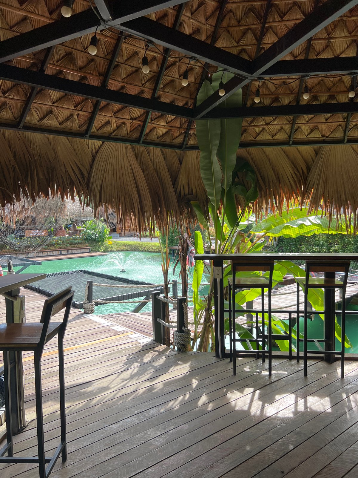 Thatched resort by a turquoise pond in southern Thailand