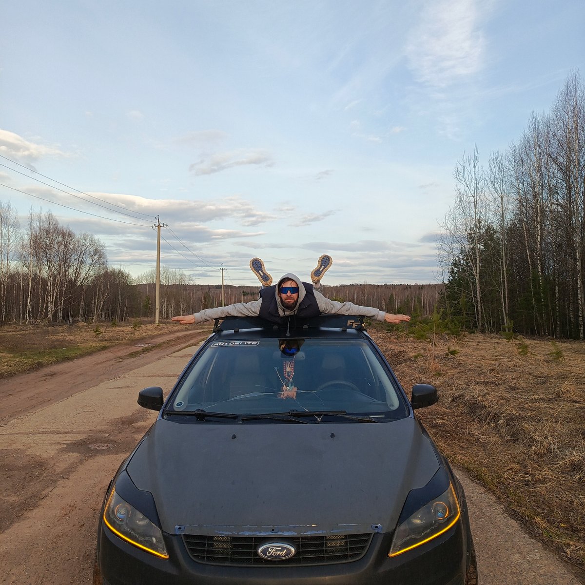 Man performs stunts on car roof in rural Russia