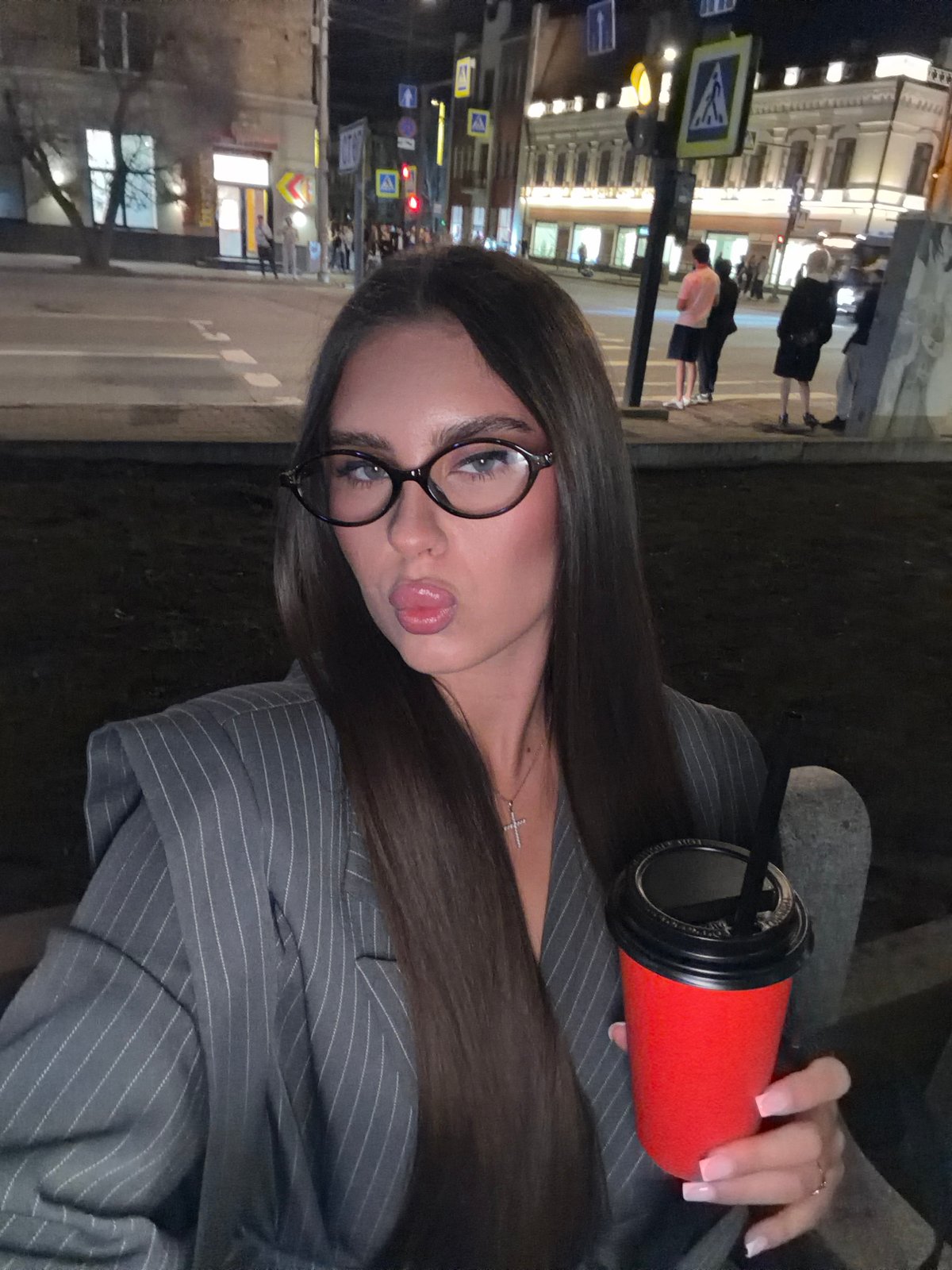 Woman with red cup photographed on Krasnoyarsk streets at night