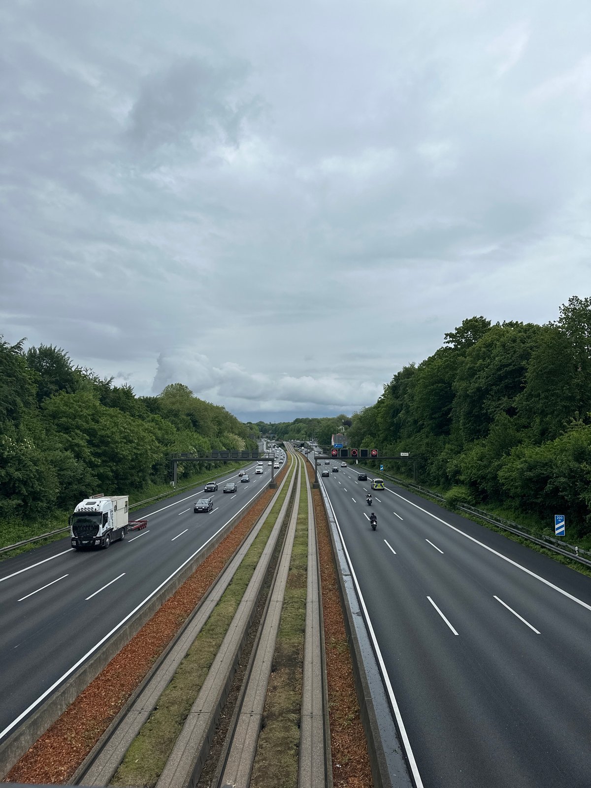 Regular traffic flows on Essen highway under cloudy skies