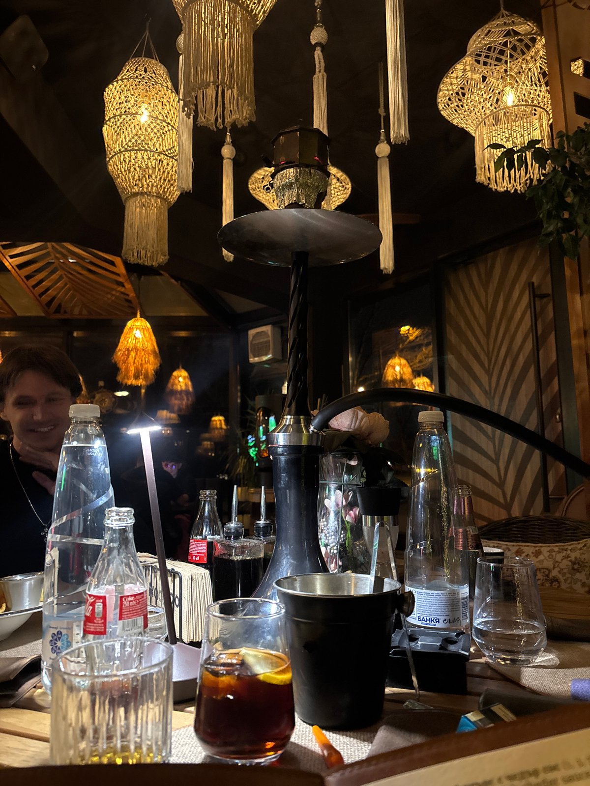 Cluttered table scene captured in dimly lit Sofia establishment